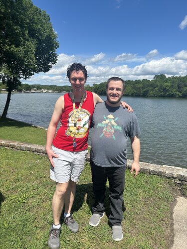 two guys in front of lake